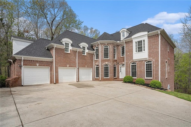 view of front of house featuring brick siding, an attached garage, a shingled roof, and driveway