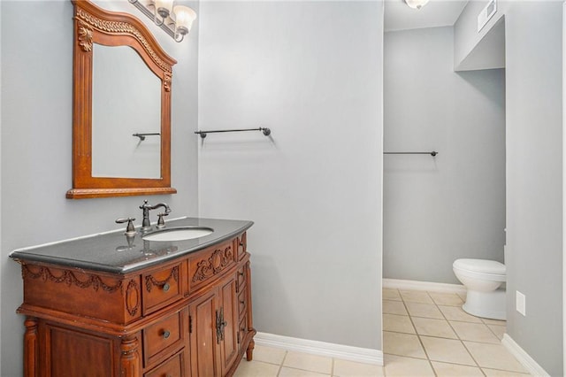 half bath featuring tile patterned floors, vanity, visible vents, and toilet