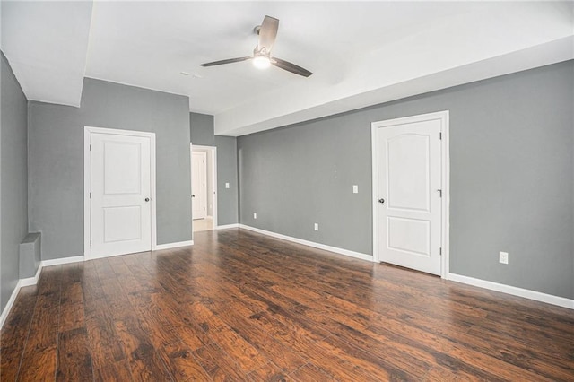 unfurnished room with baseboards, a ceiling fan, and wood finished floors