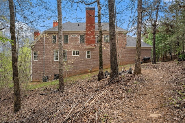 back of house with a chimney