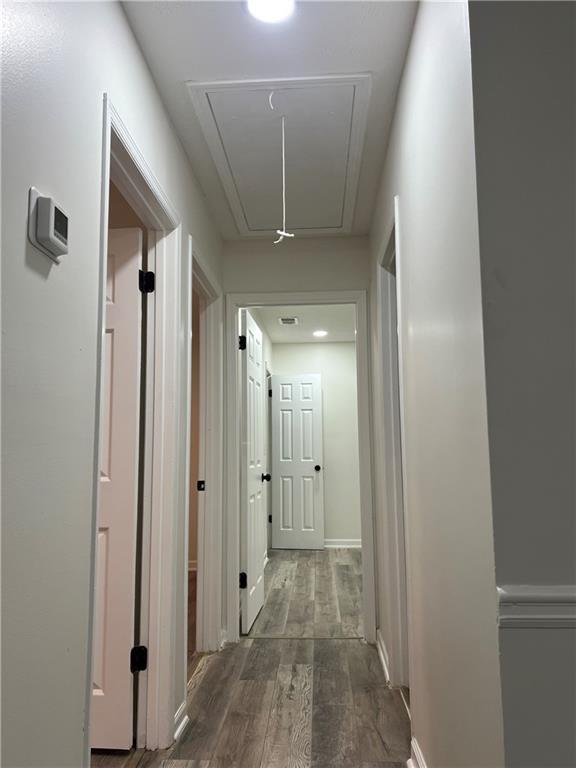 corridor featuring dark hardwood / wood-style flooring