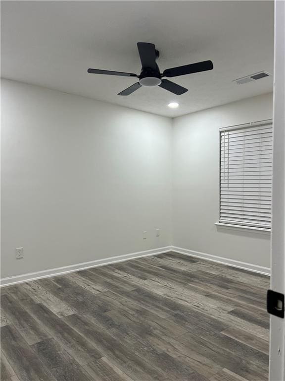 empty room featuring dark hardwood / wood-style floors and ceiling fan