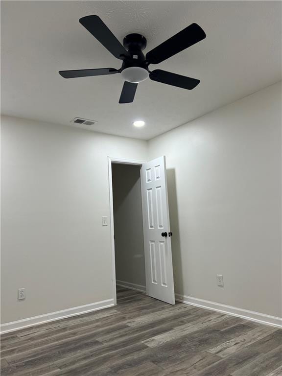 empty room with dark wood-type flooring