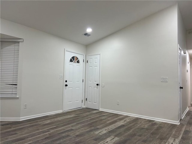 foyer featuring lofted ceiling and dark hardwood / wood-style floors