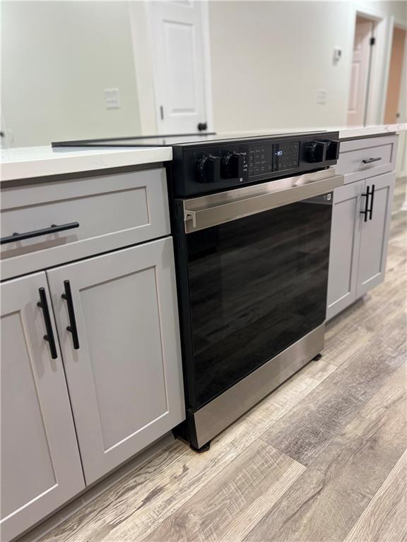 kitchen featuring electric range and light hardwood / wood-style floors