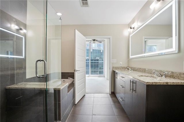 1080 Peachtree St NE Unit 804, Atlanta, GA 30309 - bathroom featuring double vanity, a garden tub, tile patterned floors, a stall shower, and a ceiling fan