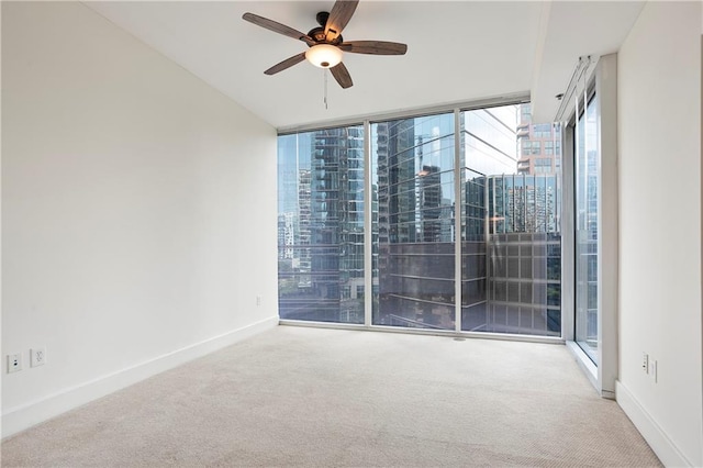 1080 Peachtree St NE Unit 804, Atlanta, GA 30309 - carpeted spare room featuring ceiling fan, a wall of windows, and a view of city