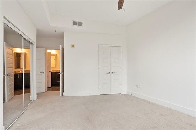 1080 Peachtree St NE Unit 804, Atlanta, GA 30309 - unfurnished bedroom featuring light carpet, ensuite bath, and a ceiling fan