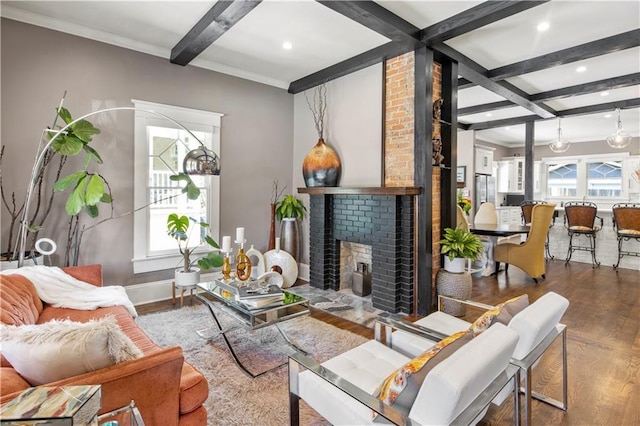 living room featuring beam ceiling, coffered ceiling, wood finished floors, and a wealth of natural light