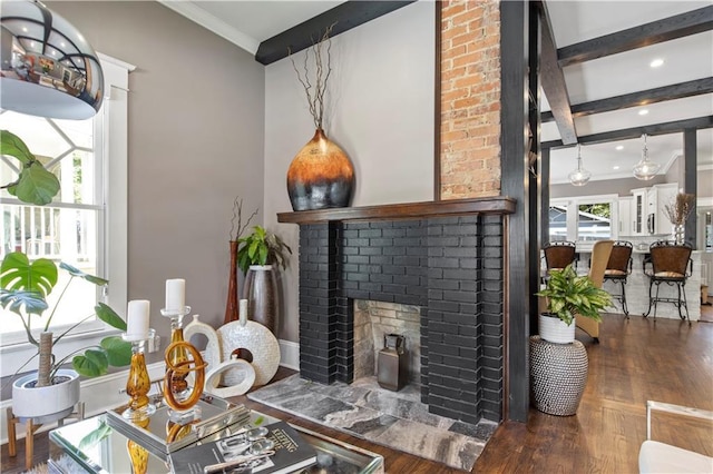 living area featuring crown molding, a fireplace, recessed lighting, and wood finished floors