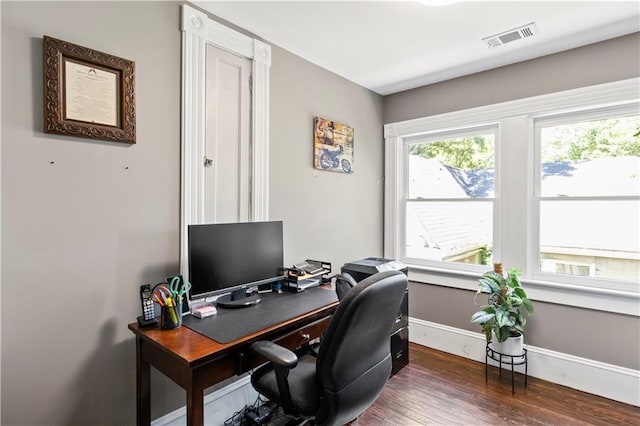 office area with baseboards, visible vents, and wood finished floors