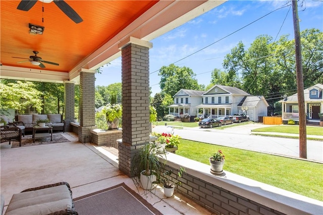 view of patio / terrace with an outdoor living space, ceiling fan, and a porch