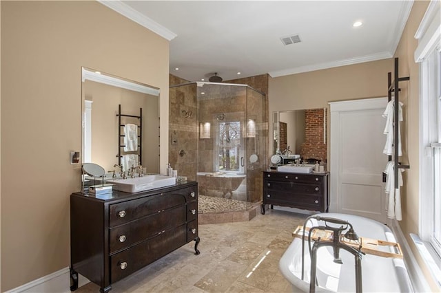 bathroom with crown molding, two vanities, a shower stall, and a sink