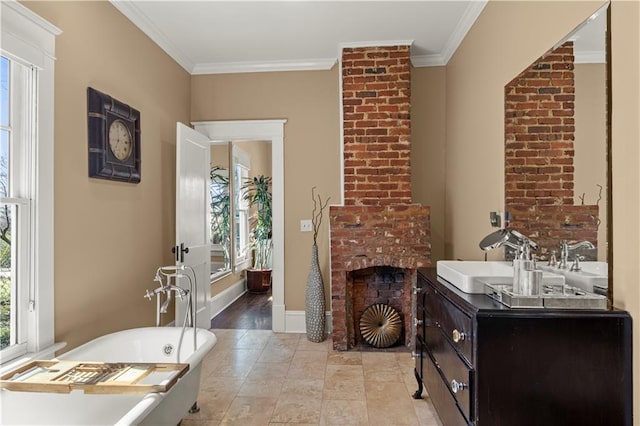bathroom with a brick fireplace, a freestanding bath, ornamental molding, and vanity