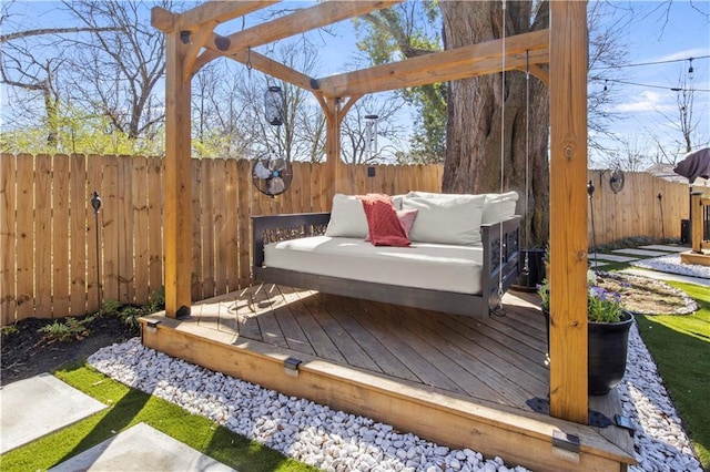 wooden terrace with a fenced backyard and an outdoor hangout area