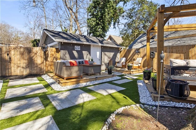 view of yard with a patio, an outdoor living space, a wooden deck, and a fenced backyard