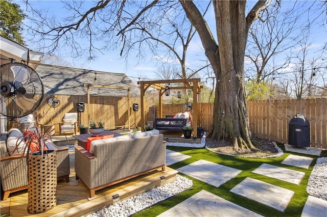 view of yard featuring an outdoor living space, a fenced backyard, a pergola, and a deck