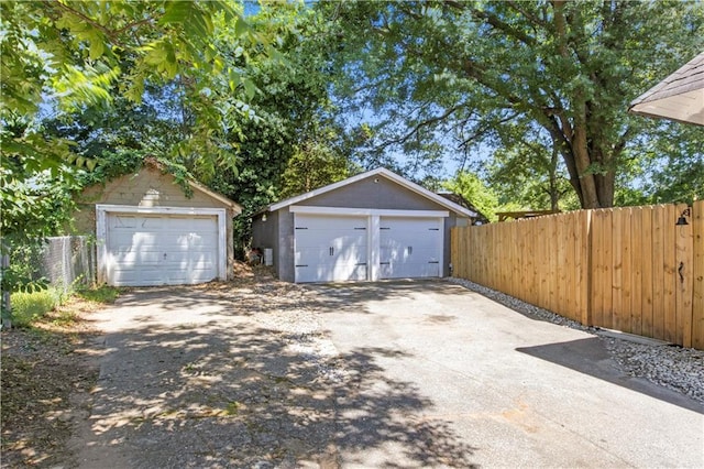 detached garage featuring fence
