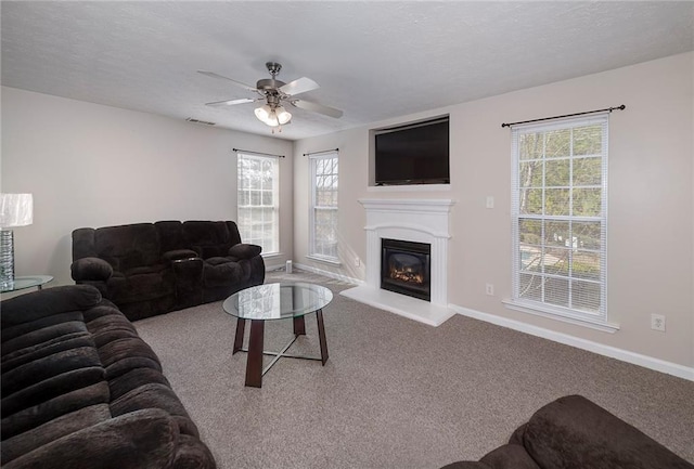 carpeted living room featuring ceiling fan