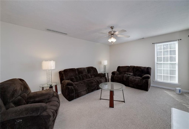 living room with ceiling fan and light colored carpet