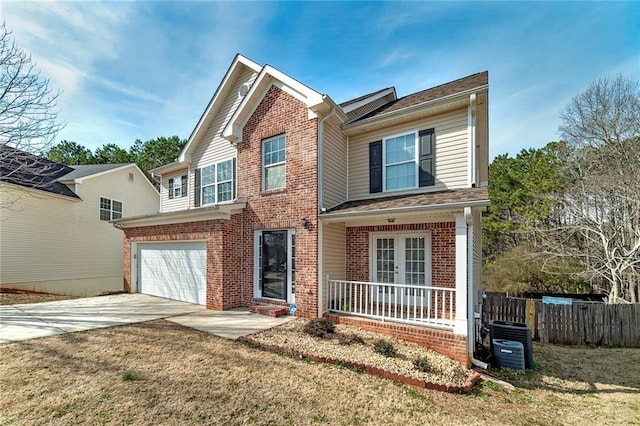 view of front of property featuring a garage, a porch, central air condition unit, and a front lawn