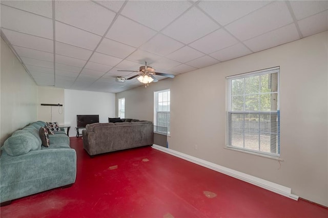 living room featuring a paneled ceiling and ceiling fan