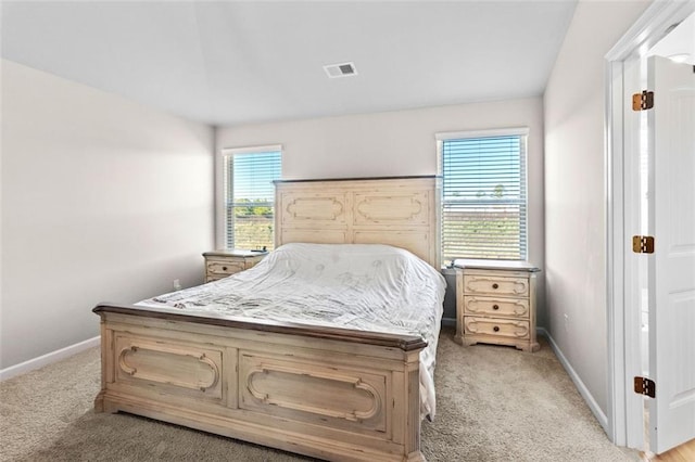 bedroom featuring light carpet