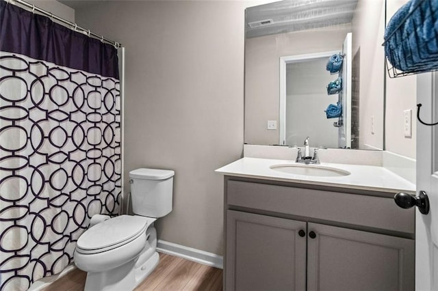 bathroom featuring hardwood / wood-style floors, vanity, and toilet