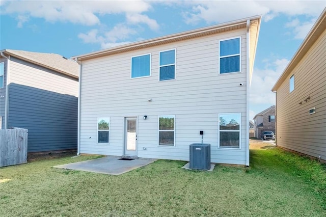 back of property with a patio, central AC unit, and a lawn