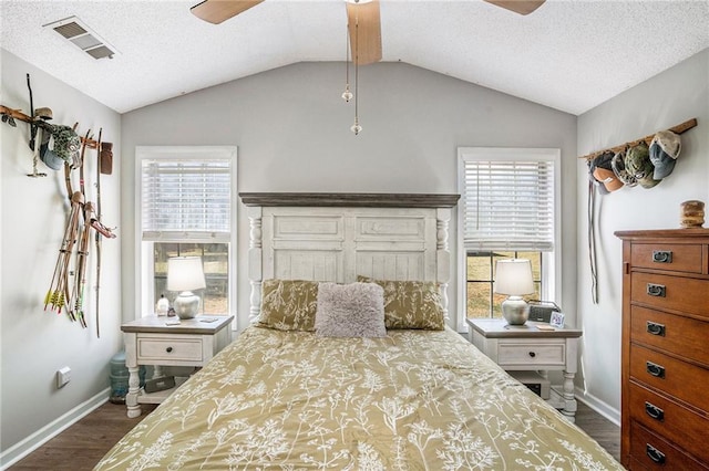 bedroom featuring lofted ceiling, dark wood-type flooring, and multiple windows