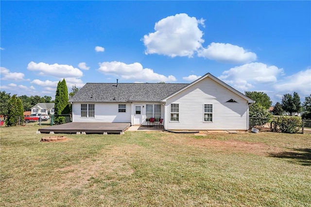 back of house with a lawn and a deck