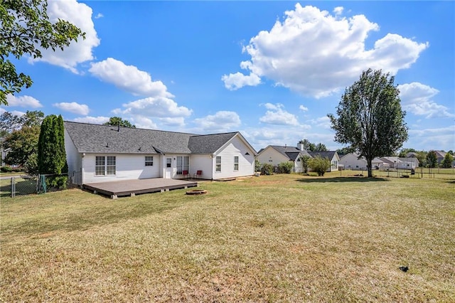 rear view of house with a yard and a deck