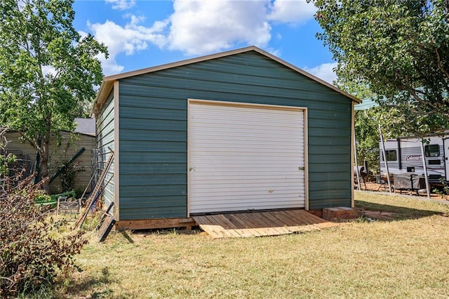 view of outbuilding with a lawn and a garage