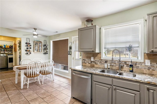 kitchen with sink, decorative backsplash, ceiling fan, appliances with stainless steel finishes, and gray cabinetry