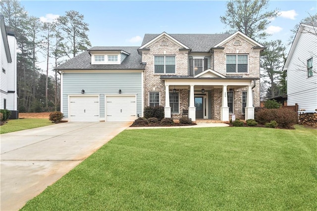 craftsman inspired home with a porch, a front lawn, and a garage