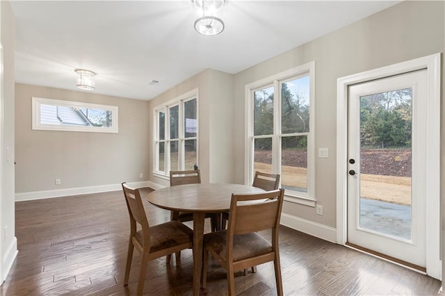 dining space with dark hardwood / wood-style floors