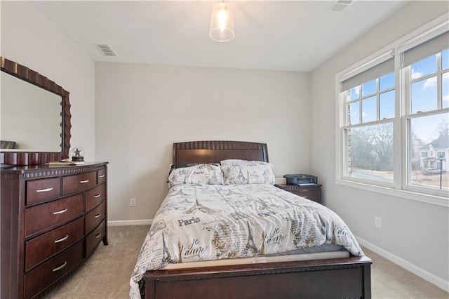 carpeted bedroom featuring multiple windows