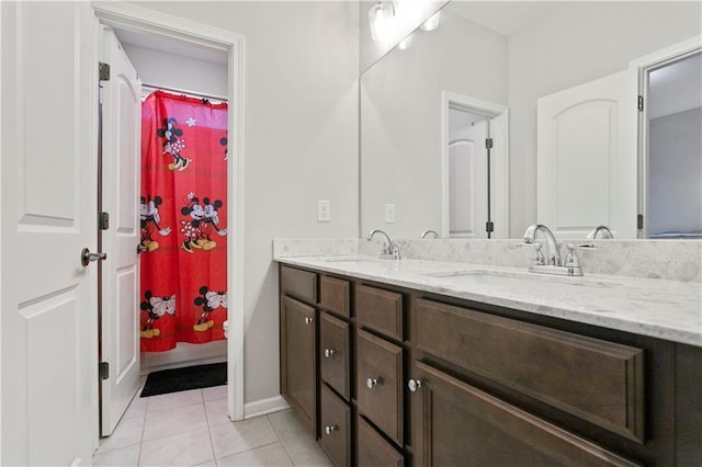 bathroom with double sink vanity and tile flooring