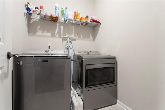 washroom with independent washer and dryer and light tile floors