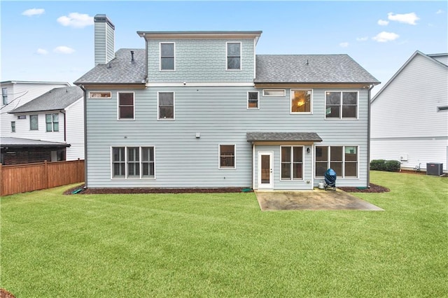 rear view of property featuring central AC unit, a patio, and a lawn