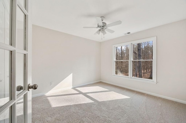 unfurnished room with french doors, ceiling fan, and carpet flooring