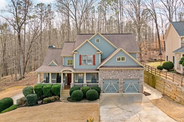 craftsman inspired home featuring a garage and covered porch