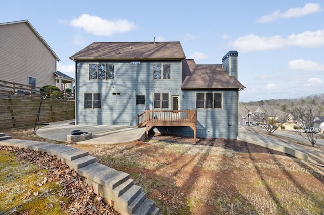 back of house with a wooden deck and a patio area