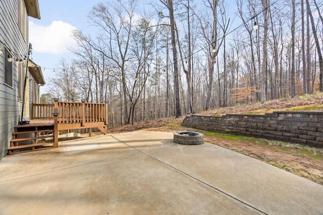 view of patio featuring a wooden deck and an outdoor fire pit