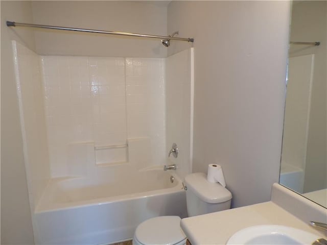 bathroom with bathtub / shower combination, vanity, and toilet