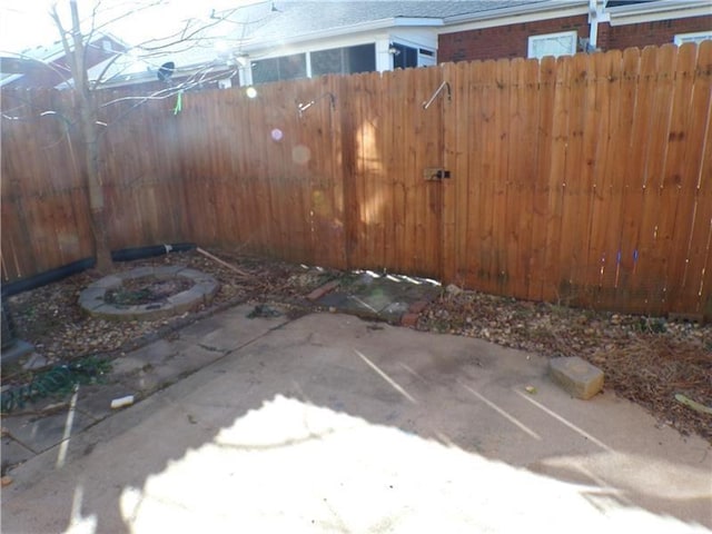 exterior space featuring a patio area, fence, and a fire pit