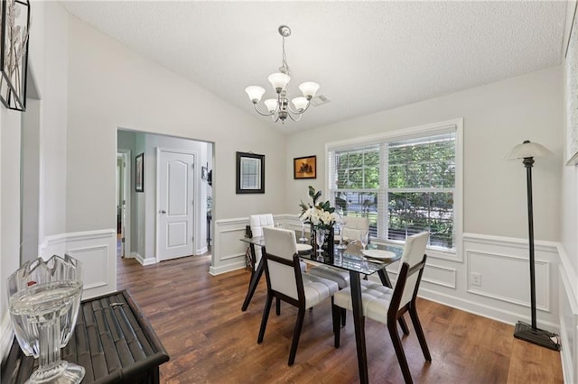 64 River Mist Cir, Jefferson, GA 30549 - dining room with a chandelier, dark wood-type flooring, a wainscoted wall, a decorative wall, and vaulted ceiling