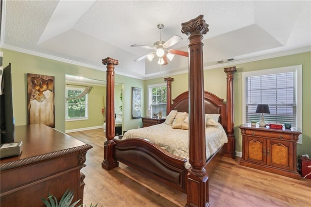 64 River Mist Cir, Jefferson, GA 30549 - bedroom with a raised ceiling, light wood-type flooring, crown molding, ornate columns, and ceiling fan