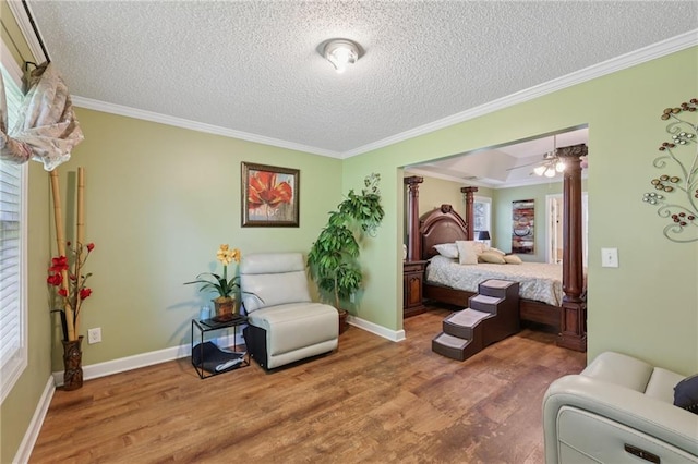 64 River Mist Cir, Jefferson, GA 30549 - bedroom with wood finished floors, a textured ceiling, crown molding, ornate columns, and multiple windows