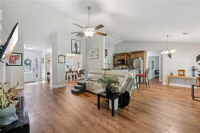 64 River Mist Cir, Jefferson, GA 30549 - living area with lofted ceiling, light wood-style floors, ceiling fan, and a chandelier